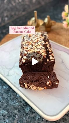 two slices of chocolate banana cake on a plate with a sign that says egg free almond banana cake