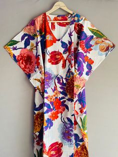 This Beautiful Indian Cotton Caftan Or Can Be Called As Tunic Is Made With Super Fine Quality Cotton And Designs Have Been Crafted By Hand Prints. Measurements :- Size - Free Size  Length -138 Cm / 54 Inches Bust/Chest Size - 87 CM/ 34 Inches Fabric - 100% Cotton Pattern - Floral Kaftan Has Adjustable Drawstring Waist To Loose Or Tight , Kaftan Has V Shape Neck Which Is 8" Inches Deep. Kaftan Is Multi-Purpose And Can Be Worn As A Cover Up At The Beach ,Lounge Wear ,Sleepwear ,Pregnant Women Hospital Gown For Newly Moms ,Maxi Dress ,Free Dress Etc . Indian Kaftan Very Comfortable To Wear In Both Hot Or Cold Weather. Kaftan Is Super Comfortable .It Will Be Loose And Free Flowing And Fabric Is Very Soft With Vibrant Color Note :-Due To Different Monitor Setting Colors May Be Little Vary To Or Multicolor Floral Print V-neck Kimono, Multicolor V-neck Kimono With Floral Print, White V-neck Floral Print Kaftan, Patterned Dresses With Floral Print And Kimono Sleeves, Patterned Dress With Floral Print And Kimono Sleeves, Multicolor Cotton Tunic Kimono, Multicolor Kaftan With Kimono Sleeves For Beach Season, White Floral Print Kaftan For Beach Cover-up, Hawaiian Multicolor Printed Dress