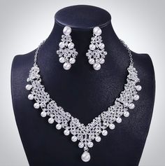 A beautiful three-piece bridal jewelry set for the romantic bride! Adorned with iridescent pearls and intricately faceted rhinestone crystals that capture the light from every angle with a perfectly translucent appeal, the pieces are rhodium plated for a flawless finish which enhances the intricate detailing and conveys a modern take on old elegance. Necklace: Length: 18" with a 2" extension chain for comfortable sizing (if you would like it longer, please include a message at the time of order Tiara Necklace, Hair Accessories Tiara, Pearl Crown, Crown Earrings, Pearl Tiara, Costume Jewelry Sets, Silver Wedding Jewelry, Bridal Jewelry Set, Rhinestone Tiara