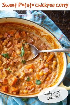 a bowl of sweet potato chickpea curry on a blue towel with a spoon