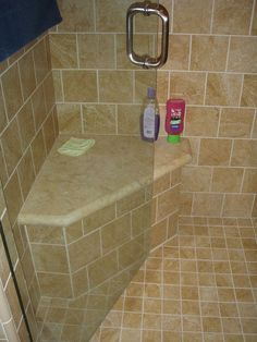 a shower stall with tiled walls and floor