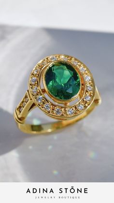 Our fan favourite vintage inspired emerald ring finished in 18k yellow gold vermeil - made to last Green Oval Ring With Bezel Setting, Oval Green Ring With Bezel Setting, Luxury Green Rings With Bezel Setting, Luxury Green Ring With Bezel Setting, Formal Green Emerald Ring With Halo Design, Formal Green Rings With Halo Setting, Oval Tsavorite Ring With Bezel Setting, Green Oval Rings With Halo Design, Classic Green Emerald Ring With Halo