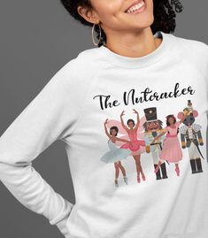 This unisex ADULT sweatshirt is inspired by The Nutcracker Ballet. Created just in time for the holiday season, it features brown ballerinas and other known characters like the Rat King, Clara, and the Sugar Plum Fairy. This soft crew neck top offers a loose fit and comfortable feel. The material is 50% cotton and 50% polyester; however, fabric content may vary based on the color you select. Be sure to view matching products to create your own gift set too. Visit The Trini Gee for more: https:// The Rat King, African American Christmas, The Nutcracker Ballet, Rat King, Mouse King, American Christmas, Ballet Gift, Black Ballerina, Nutcracker Ballet