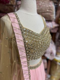 Featuring a millennial pink designer frill ruffle lehenga intricate with gotta lace, cut dana and mirror work lehenga. Completed look with contacting golden mirror, zari thread, stone and cut dana embroidered blouse and net dupatta. Fabric: Georgette This outfit can be customized in multiple colors and specific to client measurements. 120 days of production time is required and are for bulk orders only!Order are processed in store only! Final fittings/alterations not included. Minimum Order Quan Pink Party Wear Pre-draped Saree With Mirror Work, Gold Lehenga With Mirror Work In Georgette, Gold Anarkali Set With Mirror Work For Party, Gold Georgette Lehenga For Party Wear, Gold Sharara With Gota Work For Party Wear, Pink Pre-draped Saree With Mirror Work For Party, Pink Pre-draped Party Wear Saree With Mirror Work, Party Wear Gold Lehenga With Gota Work, Gold Lehenga With Mirror Work For Party