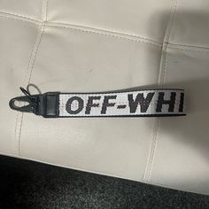 a black and white belt with the word off - wh on it's side