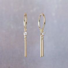 Handmade by Jack + G in Brooklyn, NY. Made in 18 gauge exclusively for Somatic 14k yellow gold 3/8" ring diameter (1) 15mm bar dangle (1) 2mm prong diamond with (1) 10mm bar dangle Sold individually - order two for a pair Elegant Yellow Gold Huggie Earrings With Dangling Charms, Minimalist Hoop Earrings With Prong Setting, Minimalist Dangle Hoop Earrings With Prong Setting, Jack G, Bobby Pins, Brooklyn, Hair Accessories, Yellow Gold, Drop Earrings