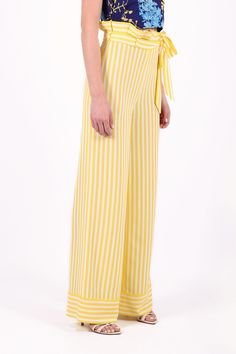 Bright white and yellow striped viscose palazzo trousers, perfect for various occasions from day to evening, such as business meetings, brunches with friends, happy hours, dinners and more or less important events. I paired it with the blue CATERINA top, but you can also wear it with another white or various colours, the important thing is that the final result is pleasing to the eye. The peculiarity is in the strap which has folds mounted upwards, blocked by the belt with which various types of Chic Striped Wide Leg Pants For Beach, Chic Striped Wide Leg Pants For Vacation, Elegant Striped Summer Pants, Elegant Summer Pants With Vertical Stripes, Elegant Striped Pants For Summer, Elegant Striped Wide Leg Pants For Summer, Chic Vertical Stripes Pants For Vacation, Chic Striped Pants For Vacation, Elegant Spring Wide Leg Pants With Vertical Stripes