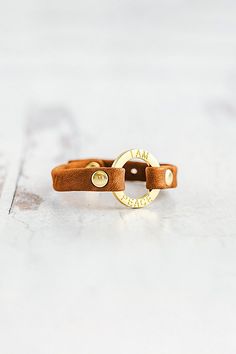 The “I Am” mantra bracelet collection was designed with the intention to empower the strength within us. Handcrafted with the softest lamb leather you’ll find the words “I AM PEACE” softly etched around the gold center ring, a daily reminder to hold space with your peace. **Contents** * Lambskin leather, zinc alloy hardware * Button clasp closure * Handmade **Care/Import** * Made in the USA **Dimensions** * Adjustable to fit wrist sizes 6.5”-8” | Giving Bracelets Gold I Am Peace Mantra Bracelet at Free People in Orange Spiritual Everyday Leather Bracelet, Peace Mantra, I Am Peace, Amber Hand-strung Bracelets For Meditation, Adjustable Leather Bracelets With Gold-tone Hardware, Spiritual Brown Leather Bracelet Hand-strung, Yellow Hand-strung Bohemian Stretch Bracelet, Hold Space, Mantra Bracelet