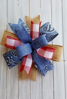 a red, white and blue bow on top of a wooden floor