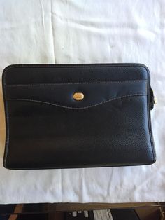 Black Dunhill leather clutch with gold-tone hardware and black lining. There is one external zipper pocket on the back and two interior zipper pockets. Dimensions = L 10.75"x D 2.5"x H 7.5".  Condition : VERY GOOD CONDITION ( 9/10 ) Fabrics : Leather  Signs of Wear:  Minor scratching on one Exterior Corner Minor nip on Exterior Trim Minor fading on Zipper-end hardware Clean and perfect inside as far as I can see Classic Formal Clutch With Zipper Closure, Formal Leather Clutch With Zipper Closure, Rectangular Clutch With Zipper Pocket For Formal Events, Formal Leather Clutch With Zipper Pouch, Leather Clutch With Zipper Pouch For Formal Occasions, Formal Clutch With Zipper Closure, Modern Formal Clutch With Zipper Pocket, Classic Business Clutch With Zipper Pouch, Business Clutch With Zipper Closure