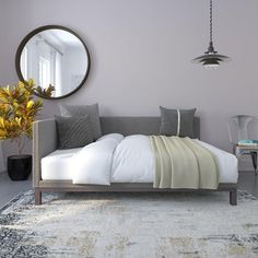 a bed sitting on top of a rug in a bedroom