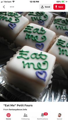 some white and blue decorated cookies on top of tin foil with writing in the middle