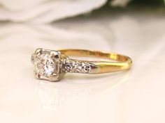 A beautiful, classic late Art Deco engagement ring setting of 14K two tone gold with a lovely simple, yet elegant effect! The center round cut diamond measures approximately 0.25 carats estimated in the H color/SI1 clarity range and faces up bright and beautiful! The 5.5mm square mount is raised 5.5mm off the finger with decorative open gold cut outs.  On either side of the center diamond are a total of six single cut melee diamonds, three on each side set in white gold beds, making the total di 1920s Ring Engagement, Art Deco Rose Gold Engagement Ring, Vintage Bridal Jewelry, Art Deco Engagement Ring Set, Gold Antique Engagement Rings, Late Art, Ring Cuts, Rose Gold Engagement Ring Vintage, Antique Engagement Rings Vintage