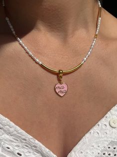 Looking for a unique and thoughtful gift for that special mother in your life? Look no further than this stunning handmade necklace featuring white freshwater pearls, shiny gold metal parts, and a beautiful heart charm made from pink enamel. Adorned with the word "Mama," this necklace is the perfect way to show your love and appreciation for the amazing mother in your life. Whether for Mother's Day, a birthday, or just because, this necklace is sure to become a treasured piece in any mother's je Mother Jewelry, Pink Enamel, Freshwater Pearl Necklace, White Freshwater Pearl, Beautiful Heart, Freshwater Pearl Necklaces, Adjustable Necklace, Heart Beads, Handmade Necklace