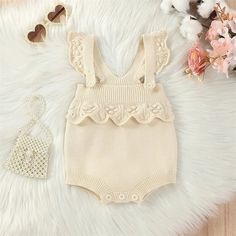 Add a playful touch to your baby girl's wardrobe with the MILA Knitted Ruffle Romper! This sleeveless romper is perfect for summer and features adorable ruffles that will make your little one stand out. Available in a variety of colors, this romper is a must-have for any stylish baby. Sleeveless Jumpsuits And Rompers With Ruffles For Playtime, Sleeveless Ruffle Bubble Romper For Playdate, Cream Sleeveless Bubble Romper With Ruffles, Playful Sleeveless Bubble Romper With Ruffles, Cream Sleeveless Cotton Bubble Romper, Pink Ruffle Bubble Romper For Playwear, Playful Sleeveless Ruffle Bubble Romper, Summer Dress-up Bubble Romper With Ruffles, Pink Floral Print Bubble Romper For Playtime