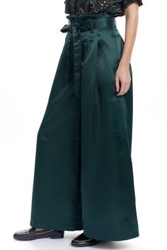 The Tony pant is a wide leg trouser with a paperbag style waist and a tie belt. There are welt back pockets and 2 side front pockets and belt loops. Shown in our exclusive Low shine satin. Content: 100% Poly Color: Pine Fits: Fitted at the waist then Relaxed Sizes: XS-L What we Love: Modern and dramatic trouser Limited Edition Made in Lovely Downtown Los Angeles Model is 5'9" size 2 and is wearing a size S Witchy Wardrobe, Witchy Outfits, Soft Dramatic, Lady Loki, Gaucho Pants, High Waist Wide Leg Pants, Fashion Tops Blouse, Satin Pants, Silk Trousers