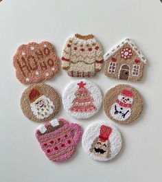 six embroidered christmas ornaments on a white surface