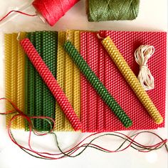 several different colored threads and spools on a table