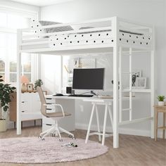 a white loft bed with desk and computer on it in a room next to a window