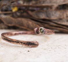 Bangle copper bracelet Rustic jewelry Bangles hammered copper Anniversary gift for wife Raw gemstone bracelets Boho Jewelry Minimalistic Reach for the sun with the Peridot crystal, an effervescent stone that harnesses the life-giving energy that turns night into day. The Vitamin D of your healing crystal collection, the Peridot crystal meaning is connected to the sun, making it your spiritual cheerleader that keeps you on the sunny side of life. The Peridot crystal shines like a light beam of en Unique Hammered Bracelets As Gift, Unique Hammered Bracelets For Gift, Unique Hammered Bracelets For Gifts, Bohemian Hammered Bracelets As Gift, Bronze Hammered Bracelet As Gift, Adjustable Hammered Bronze Bracelets, Rustic Copper Bracelets As Gift, Hammered Rose Gold Copper Jewelry, Spiritual Hand Forged Cuff Bracelet Gift