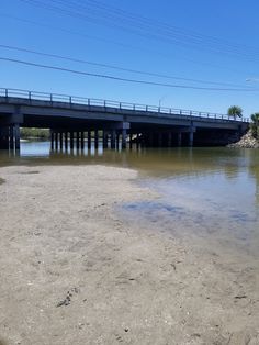 a bridge over water with power lines above it