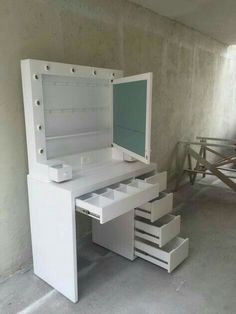 a white desk with drawers and a mirror