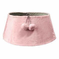 a pink lampshade with two pom - poms hanging from the bottom