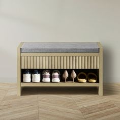 a wooden bench with several pairs of shoes on it