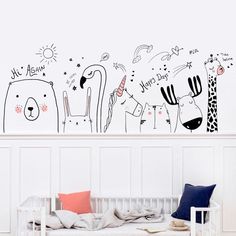 a white crib in front of a wall with cartoon animals on it