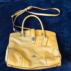 New Without Tags Coach Purse/Handbag In Mustard, Yellow Color. Perfect For The Fall Coming Up. Has Handles And Also A Long Strap So It Can Be Worn As A Crossbody. 11” Wide, 7” Deep. Yellow Travel Bag With Branded Hardware, Classic Yellow Satchel With Top Carry Handle, Elegant Yellow Bag With Branded Hardware, Elegant Yellow Bags With Branded Hardware, Classic Yellow Satchel With Detachable Handle, Yellow Shoulder Bag With Branded Hardware For Travel, Classic Yellow Satchel With Gold-tone Hardware, Classic Yellow Crossbody Satchel, Classic Yellow Shoulder Bag With Handles