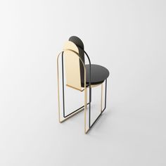 a black and white chair with a gold frame on it's back, sitting in front of a white wall