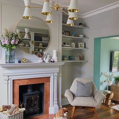 a living room with a fire place and a dog sitting on the floor