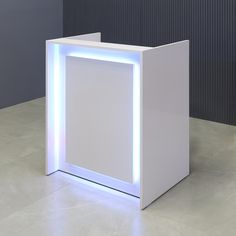 an illuminated white box sitting on top of a floor