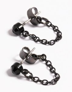 pair of black chain and ball earrings on white background with clippings to the side