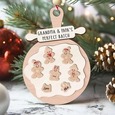 a christmas ornament with gingerbread cookies on it and the words grandma & papa's perfect batch