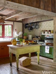 a kitchen with an island in the middle and lots of pots on top of it