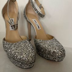 New Authentic Jimmy Choo Silver Glitter Leather Stiletto Heels. Size 40.5 (Us 7.5) Heel Height 12 Cm, Platform Height 3 Cm. Please Do Not Ask Me To Text You Or Someone Else With Extra Pictures Or Videos Of The Item. These Pictures Are Enough! All Shoes Listed Are New And Never Been Used, So They Are In Tip Top Condition And Damage Free. If Interested Purchase Or Make Offer Glitter Open Heel Heels For Gala, Luxury Party Heels With Glitter Accents, Luxury Glitter Accented Heels For Party, Luxury Glitter Heels With Round Toe, Sparkling Round Toe Heels For Cocktail, Evening Glitter Heels With Almond Toe, Glitter High Heels For Cocktail, Formal Glitter Wedding Shoes With Ankle Strap, Glitter Ankle Strap Heels For Events