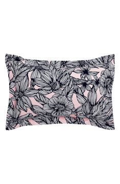 a black and white floral print pillow case on a pink background with the words,