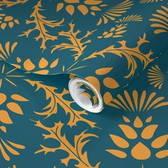 a blue and gold wallpaper with an ornate design on the back ground, featuring leaves and flowers