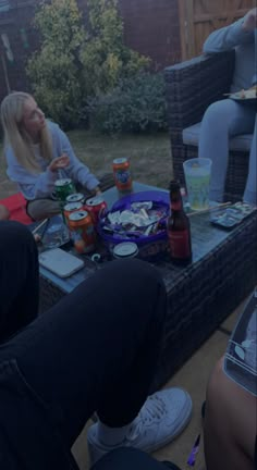 several people sitting around a table with food on it