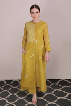 Ochre tunic with all-over floral embroidery, checkered print, ruffle detailing at the neckline, button placket and full sleeves.
Component: 1
Printed, Embroidered
Neckline: Round
Sleeve Length: Full
Fabric: Linen
Color: Yellow
Straight kurta
Sheer sleeves
Button placket
Note: The pant worn by the model is not for sale - Aza Fashions Fall Chikankari Embroidery Kurta, Fall Floral Embroidered Straight Kurta, Straight Kurta With Set-in Sleeves For Spring, Traditional Spring Kurta With Set-in Sleeves, Spring Festive Kurta With Set-in Sleeves, Fall Sets With Set-in Long Sleeves, Designer Spring Kurta With Set-in Sleeves, Designer Wear Spring Kurta With Set-in Sleeves, Long Sleeve Kurta With Floral Embroidery For Work