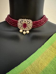 Ruby beads with CZ stones and pearls pendant with matching earrings  choker set Handmade jewelry  Silver-plated jewelry  One gram gold jewelry Official Website globusfashions.com 🌸 S H O P . M O R E . S T Y L E S  🌸 https://www.etsy.com/shop/Globusfashions Necklaces -  https://www.etsy.com/shop/Globusfashions?section_id=18712263 Bracelets - https://www.etsy.com/shop/Globusfashions?section_id=18969767 Pendant Sets - https://www.etsy.com/shop/Globusfashions?section_id=18707402 Tikka - https://www.etsy.com/shop/Globusfashions?section_id=20096802 Bangles - https://www.etsy.com/shop/Globusfashions?section_id=20105376 Anklets - https://www.etsy.com/shop/Globusfashions?section_id=20319051 Hair Clips - https://www.etsy.com/shop/Globusfashions?section_id=20322585 Saree Pins - https://www.etsy.com Party Jewelry With Pearl Pendant And Crystal, Diamond Pearl Drop Jewelry For Party, Party Jewelry With Diamond And Pearl Drop, Jeweled Bridal Necklace For Party, Jeweled Round Bridal Necklace For Party, Party Jewelry With Pearl Pendant And Round Beads, Gold Jeweled Beaded Necklace For Wedding, Party Pearl Drop Necklace With Cubic Zirconia, Formal Crystal Jewelry With Pearl Chain