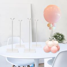 a white table with balloons and candles on it