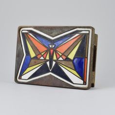 an old metal box with colorful designs on it