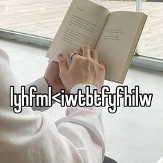 a person sitting down reading a book with the words lyffmi / iwttbftfyfilw above them