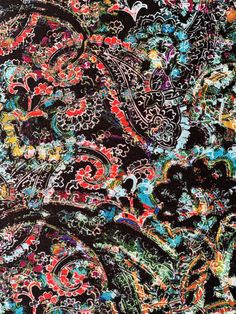 an image of a black and red paisley print fabric with lots of colorful flowers on it