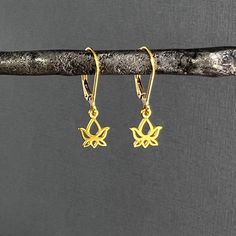 ✦The tiny lotus flower charms are made of 24k gold vermeil (gold over 925 sterling silver) and are securely attached to 14k gold filled lever back ear wires.  Lotus flowers measure about 6mm and earring length is about 1 inch total.  Also available with 14k gold filled French hook ear wires.  Please select ear wire style at check out. ✦Lotus Flower Symbolism The lotus flower represents one symbol of fortune in Buddhism. It grows in muddy water, and it is this environment that gives forth the flower's first and most literal meaning: rising and blooming above the murk to achieve enlightenment.  The second meaning, which is related to the first is purification. It resembles the purifying of the spirit which is born into murkiness.  The third meaning refers to faithfulness. Those who are worki Lotus Flower Symbolism, Flower Symbolism, Brazilian Gold, Tiny Pendant, Lotus Earrings, Securely Attached, Lotus Flowers, Yoga Jewelry, Leverback Earrings