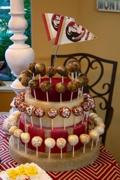 there is a cake that has been decorated with flags and candies on the table