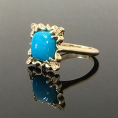 "14K Yellow Gold Turquoise and Diamond Ring METAL: 14K Yellow Gold TOTAL WEIGHT: 7.5 g TURQUOISE: Cushion Cabochon AAA Sleeping Beauty Turquoise Mined in Arizona 10 mm x 10 mm DIAMONDS: 4 Round Brilliant Cut Diamonds COLOR: H CLARITY: VS2 TOTAL WEIGHT: 0.04 SIZE: Ladies size 4-12. Please indicate your ring size at checkout. DESCRIPTION: This original design features an 10mm x 10mm Sleeping Beauty Turquoise. It has a sunburst design surrounding it, with a diamond set in each corner of the \"halo\ 14k Yellow Gold Turquoise Cabochon Ring, Heirloom Yellow Gold Turquoise Cabochon Ring, Fine Jewelry Blue Turquoise Cabochon Ring, 14k Gold Turquoise Cabochon Ring, Fine Jewelry Turquoise Cabochon Ring In 14k Gold, Fine Jewelry 14k Gold Turquoise Cabochon Ring, 14k Gold Blue Oval Cabochon Turquoise Ring, Blue Oval Cabochon Turquoise Ring In 14k Gold, Blue Turquoise Oval Cabochon Ring In 14k Gold