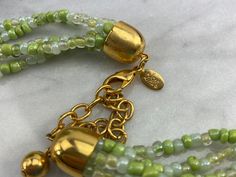 "A large bib statement necklace, featuring green glass beads and orange tone mother of pearl shell disks and sequins. By Joan Rivers. Necklace measures about 20\" up to about 23\" long depending on where you hook the clasp (measured at the shortest strand). Marked with \"Joan Rivers\" on hang tag. Some wear to the metal finish. Props shown in photos is for display purposes only, not included in this listing. As always, satisfaction is guaranteed. Thanks for shopping Vintage In Bloom! More neckla Green Costume Jewelry Beaded Necklace, Beach Costume, Joan Rivers Jewelry, Orange Tone, Bib Necklaces, Necklace Green, Joan Rivers, Pearl Shell, Bib Necklace